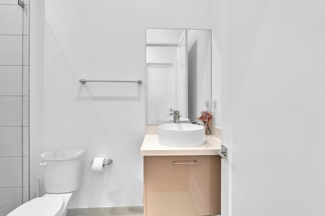 bathroom featuring toilet and vanity