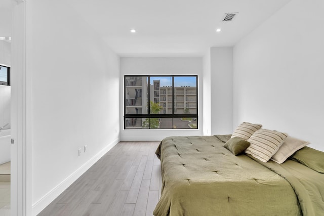 bedroom with hardwood / wood-style flooring