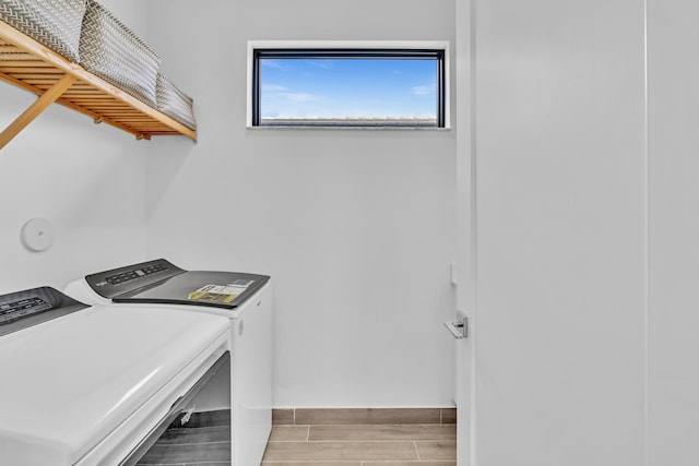 clothes washing area featuring washer and clothes dryer