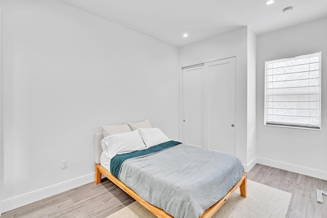 bedroom featuring light hardwood / wood-style flooring and a closet