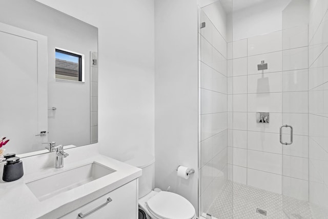 bathroom featuring toilet, an enclosed shower, and vanity