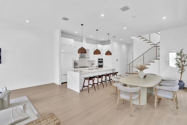 dining room with sink and light hardwood / wood-style flooring