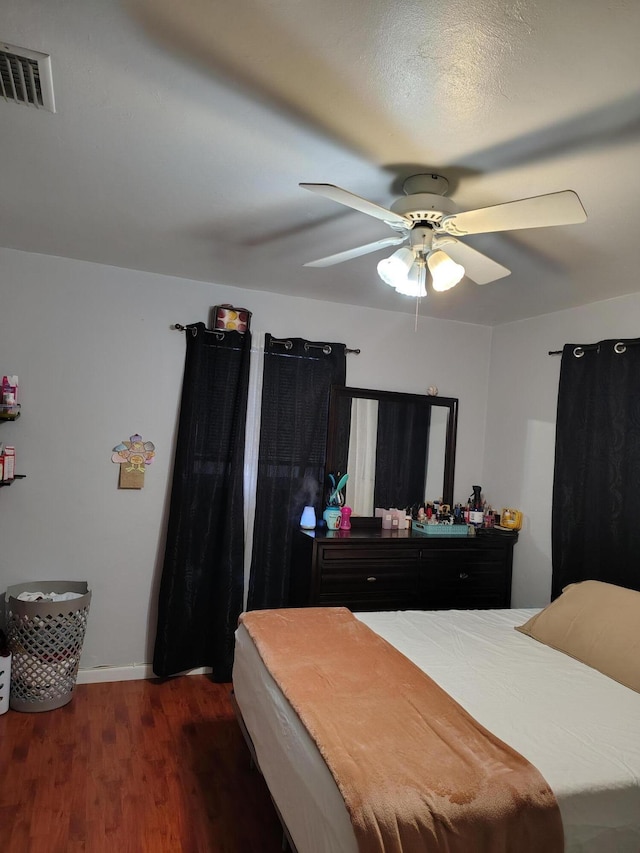 bedroom featuring dark hardwood / wood-style floors and ceiling fan