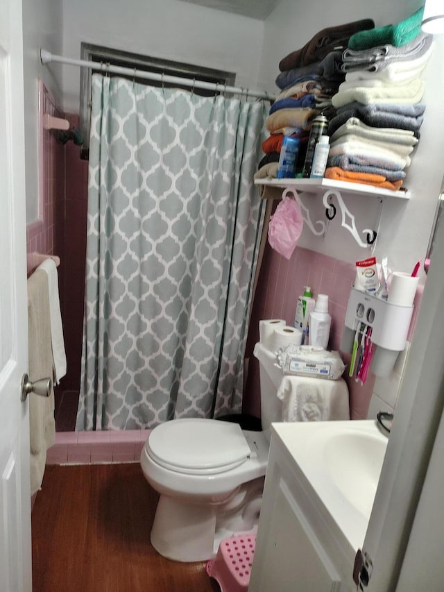 bathroom featuring vanity, toilet, curtained shower, and hardwood / wood-style floors