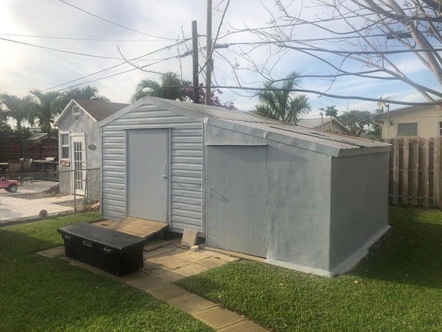 view of outbuilding with a yard