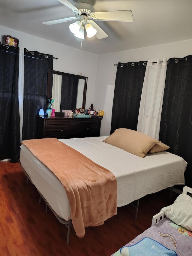 bedroom featuring ceiling fan and dark hardwood / wood-style floors