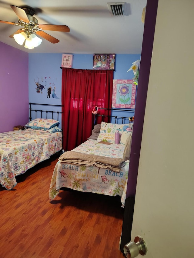 bedroom featuring ceiling fan and hardwood / wood-style flooring