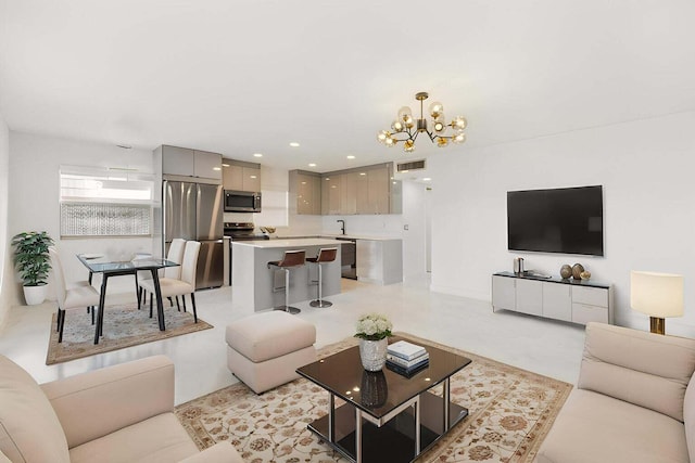 living room featuring sink and a notable chandelier