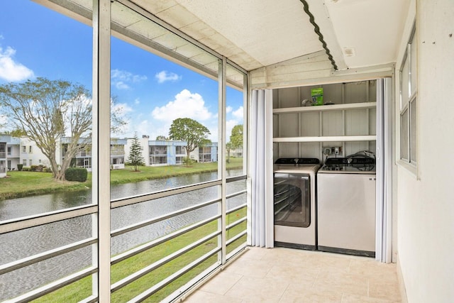 laundry room featuring washer and dryer, laundry area, and a water view