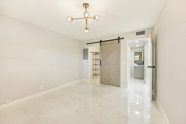 empty room with electric panel, an inviting chandelier, and a barn door