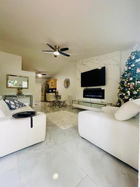 living room with vaulted ceiling and ceiling fan