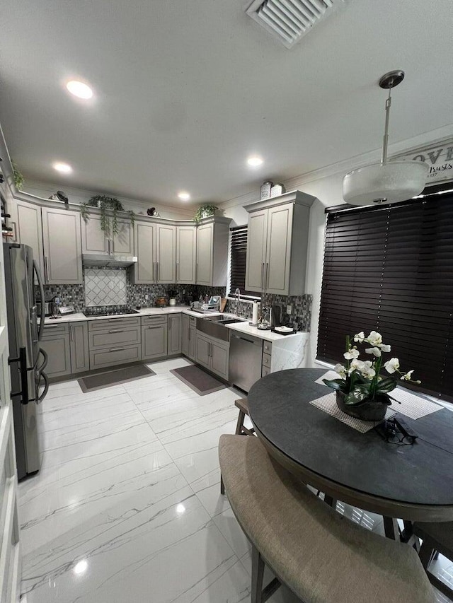 kitchen with decorative backsplash, sink, appliances with stainless steel finishes, and gray cabinets