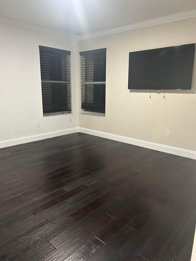 spare room featuring hardwood / wood-style floors and crown molding