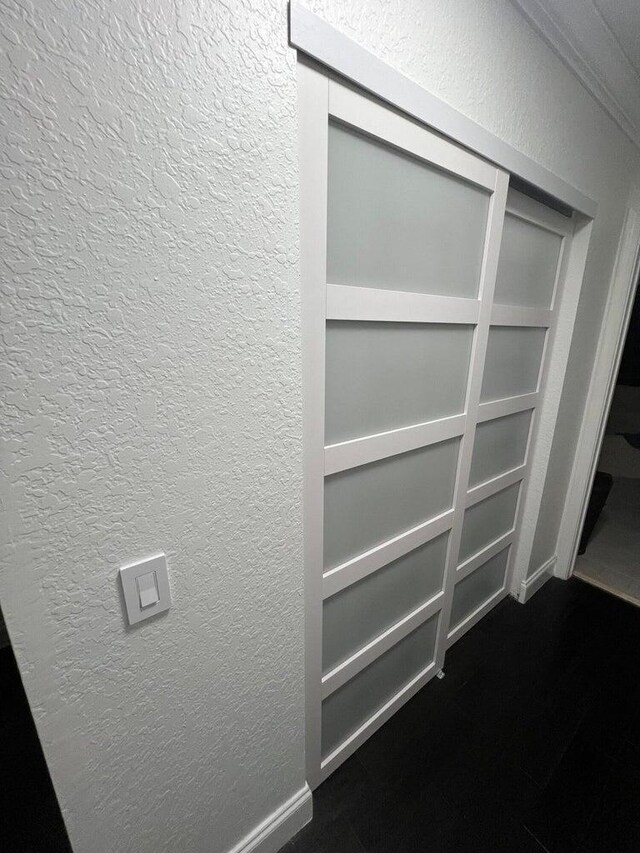 corridor featuring hardwood / wood-style flooring and crown molding