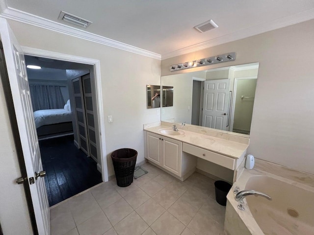 bathroom with crown molding, a tub, tile patterned flooring, and vanity