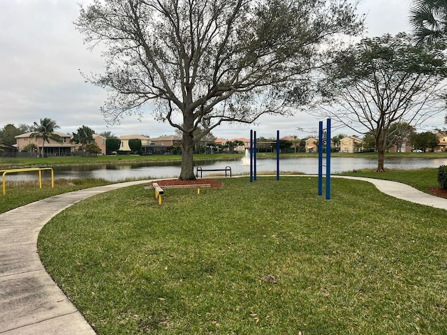 view of community featuring a yard and a water view