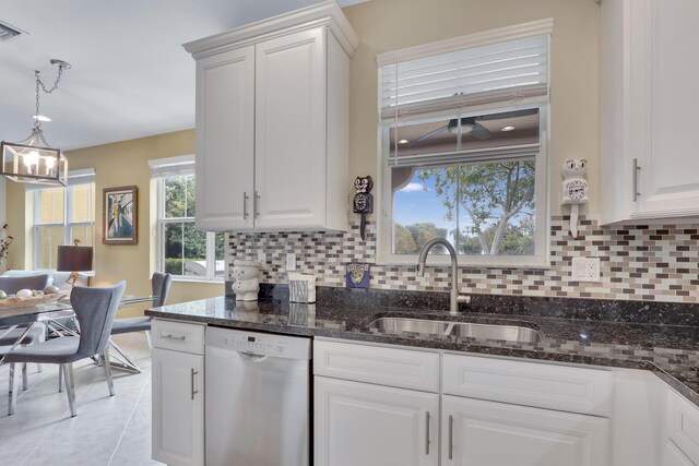 kitchen with white cabinets, a sink, decorative light fixtures, and stainless steel dishwasher