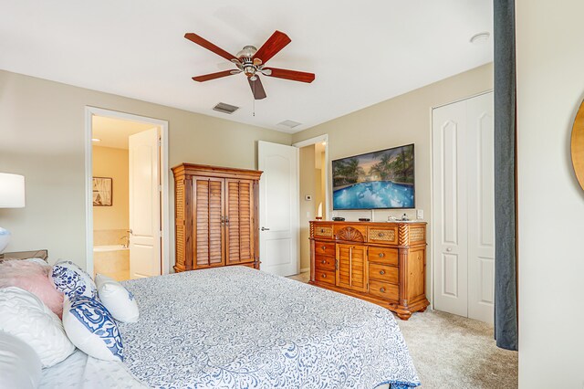 bedroom featuring carpet, visible vents, ceiling fan, and connected bathroom