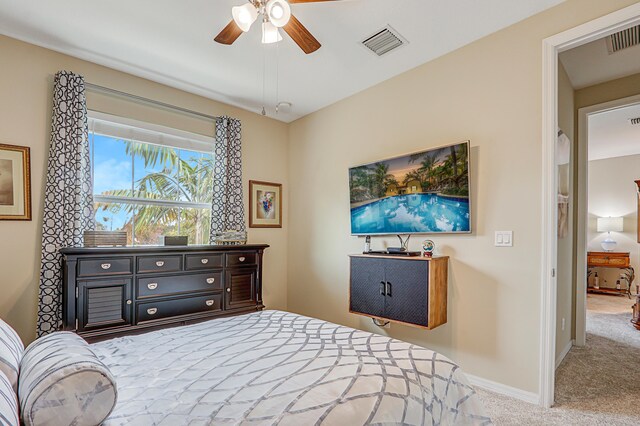 bedroom featuring light carpet, a ceiling fan, visible vents, and baseboards