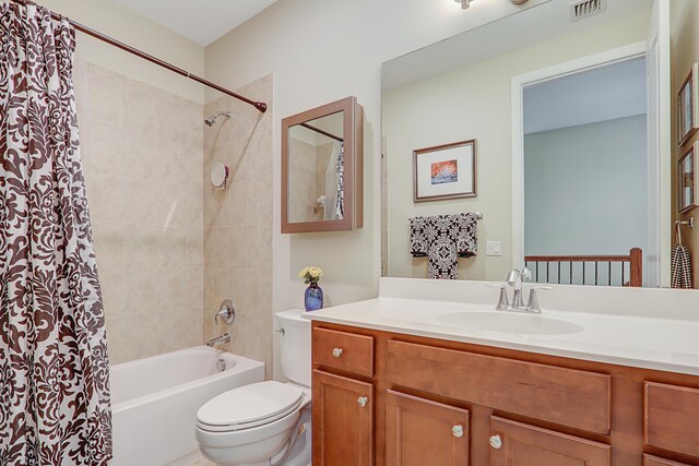 bathroom with shower / bath combination with curtain, visible vents, vanity, and toilet