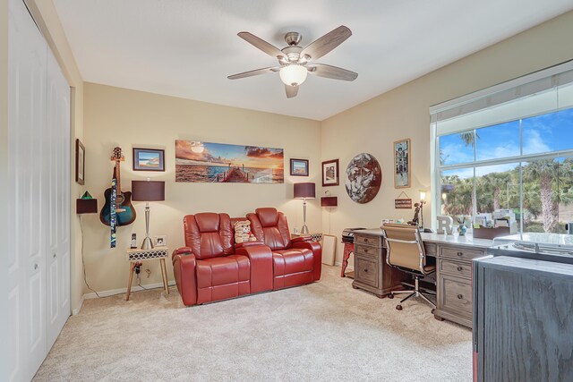 office with light carpet, baseboards, and a ceiling fan