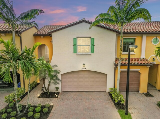 mediterranean / spanish-style house with a tile roof and stucco siding