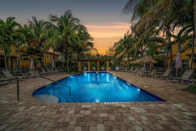 community pool featuring a patio area, fence, and a pergola