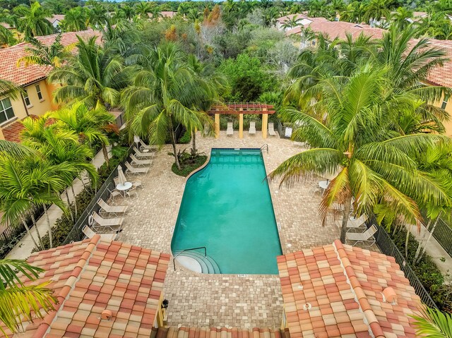 pool with a patio area, fence, and a pergola