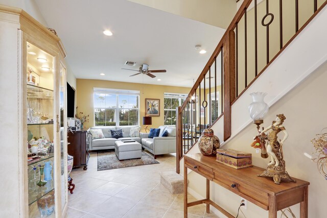 living room with light tile patterned floors, recessed lighting, visible vents, ceiling fan, and stairs