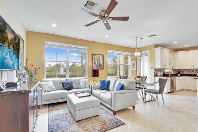 living room with light tile patterned flooring, visible vents, and recessed lighting