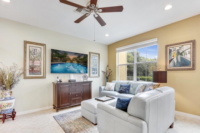 living area featuring recessed lighting, ceiling fan, baseboards, and light tile patterned floors