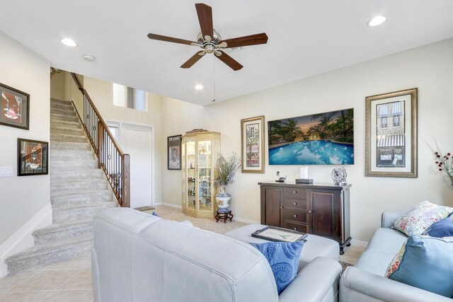 living room with light tile patterned floors, stairs, baseboards, and recessed lighting