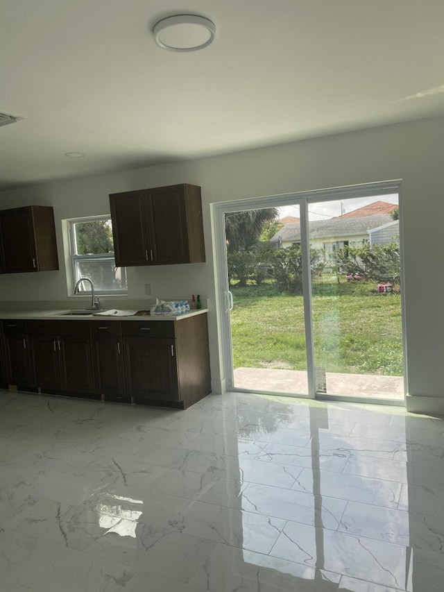 kitchen with sink and dark brown cabinetry