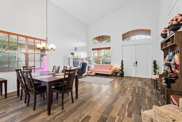 dining room with high vaulted ceiling, an inviting chandelier, plenty of natural light, and dark hardwood / wood-style flooring