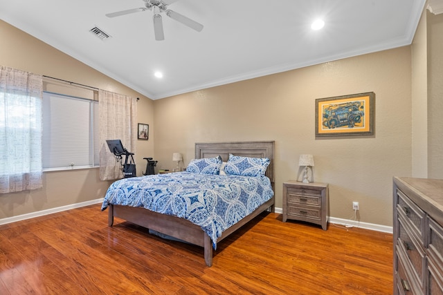 bedroom featuring ceiling fan, ornamental molding, vaulted ceiling, and hardwood / wood-style flooring