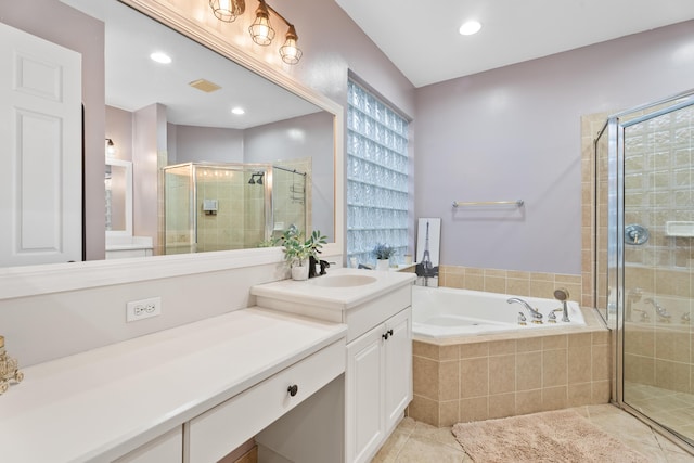 bathroom featuring tile patterned flooring, vanity, and shower with separate bathtub