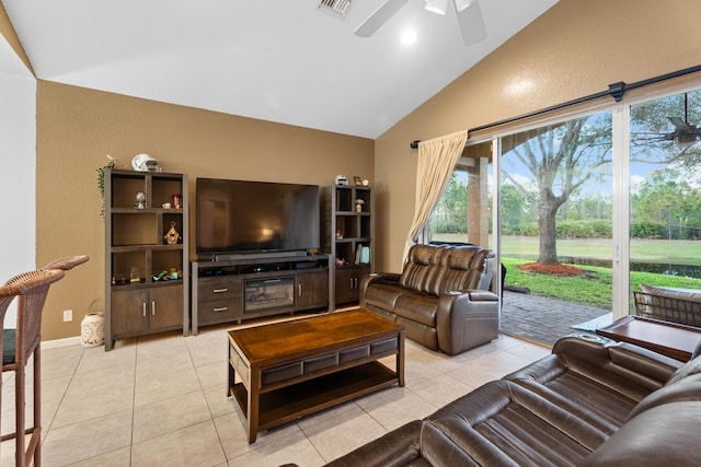 living room featuring vaulted ceiling, light tile patterned floors, and ceiling fan