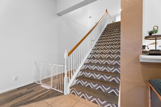 stairway featuring tile patterned flooring