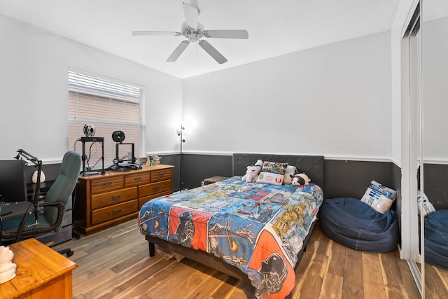 bedroom with a closet, ceiling fan, and hardwood / wood-style floors