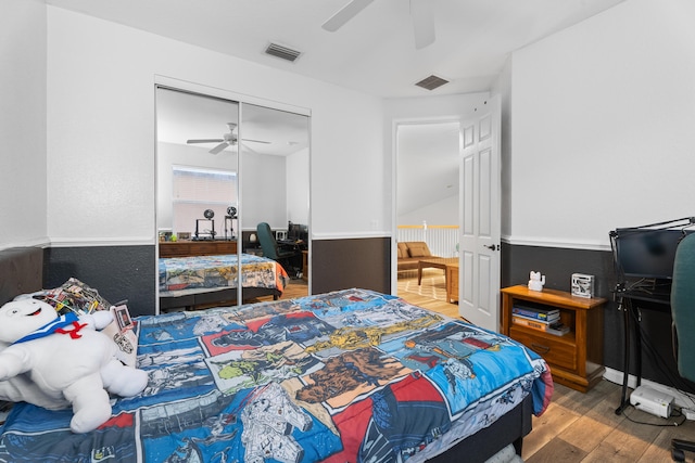 bedroom with a closet, ceiling fan, and wood-type flooring