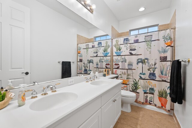 bathroom featuring vanity, toilet, tile patterned floors, and a shower with curtain