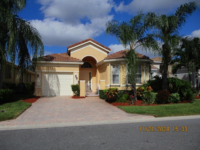 mediterranean / spanish-style home with a garage