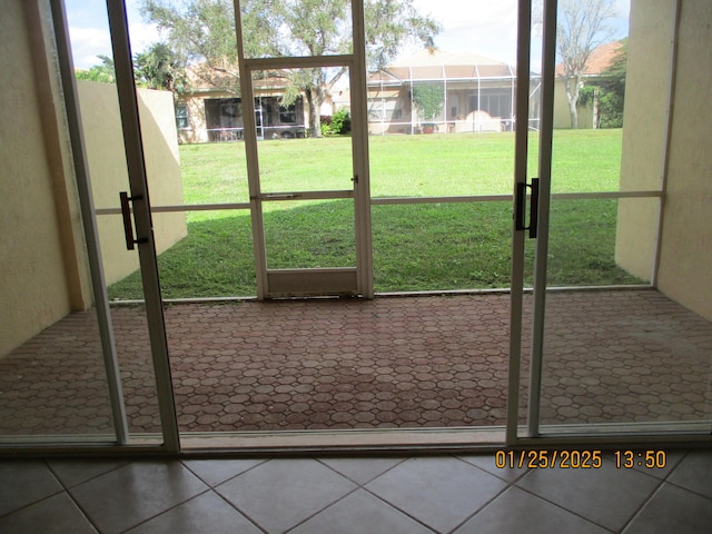 entryway with a wealth of natural light and tile patterned floors