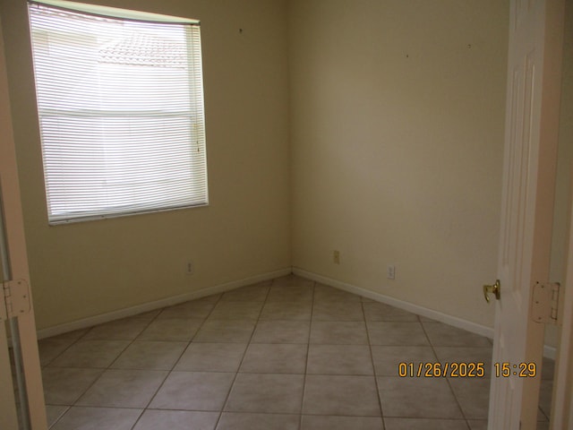 empty room with light tile patterned floors