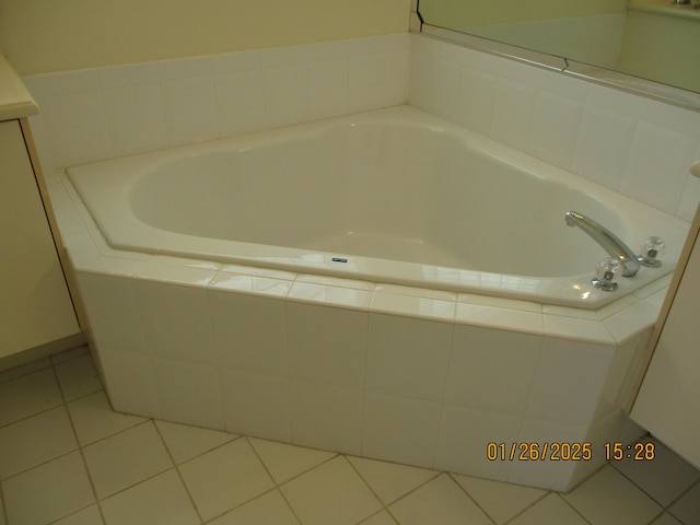 bathroom featuring a relaxing tiled tub and tile patterned floors