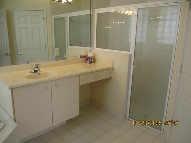 bathroom with vanity, a shower with shower door, and tile patterned floors