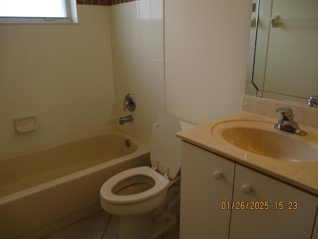 full bathroom with tiled shower / bath, vanity, toilet, and tile patterned floors