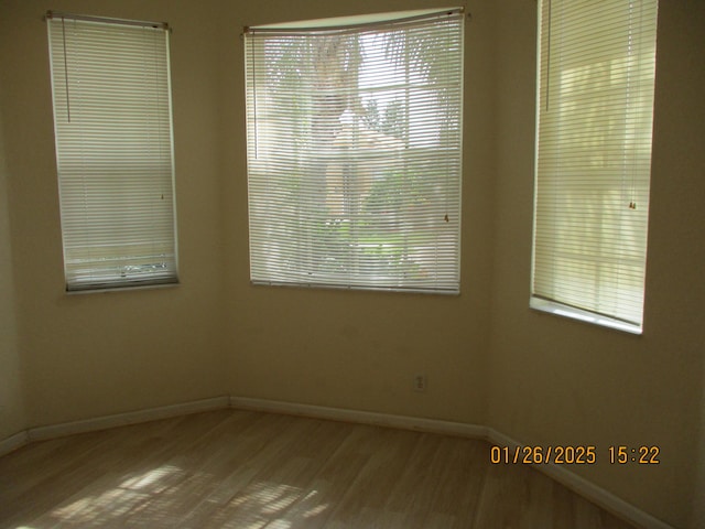 unfurnished room with hardwood / wood-style flooring