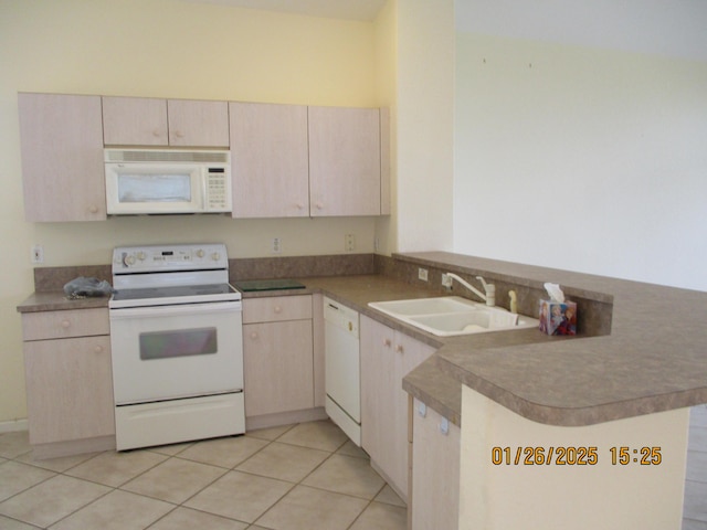 kitchen featuring sink, white appliances, light tile patterned flooring, kitchen peninsula, and light brown cabinets