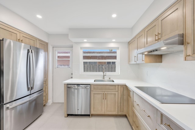 kitchen featuring light brown cabinetry, sink, and appliances with stainless steel finishes